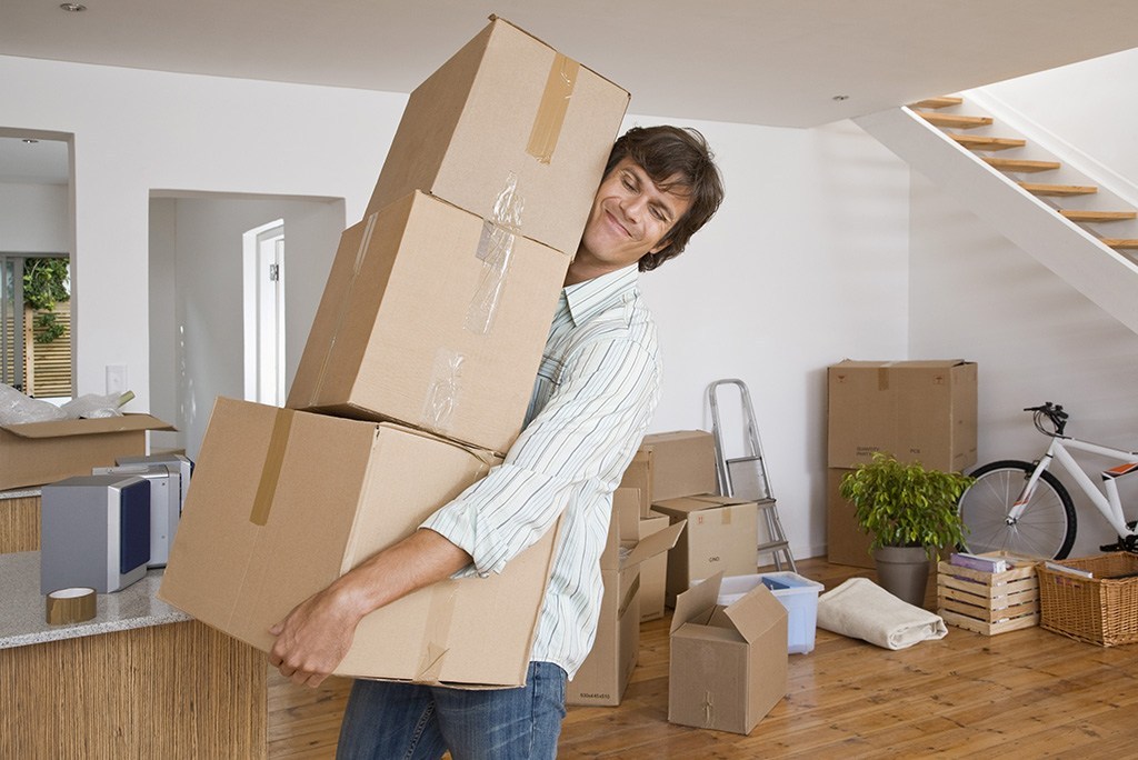 Man carrying heavy moving boxes