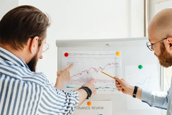 2 person looking at chart